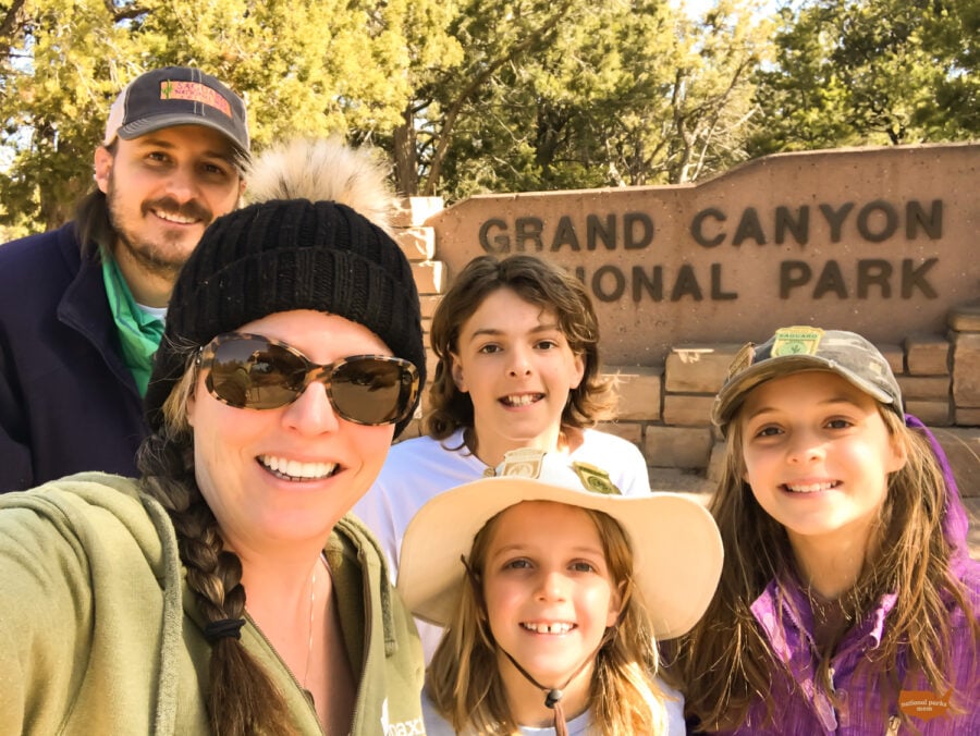 family selfie in front of the Grand Canyon NP sign, south rim