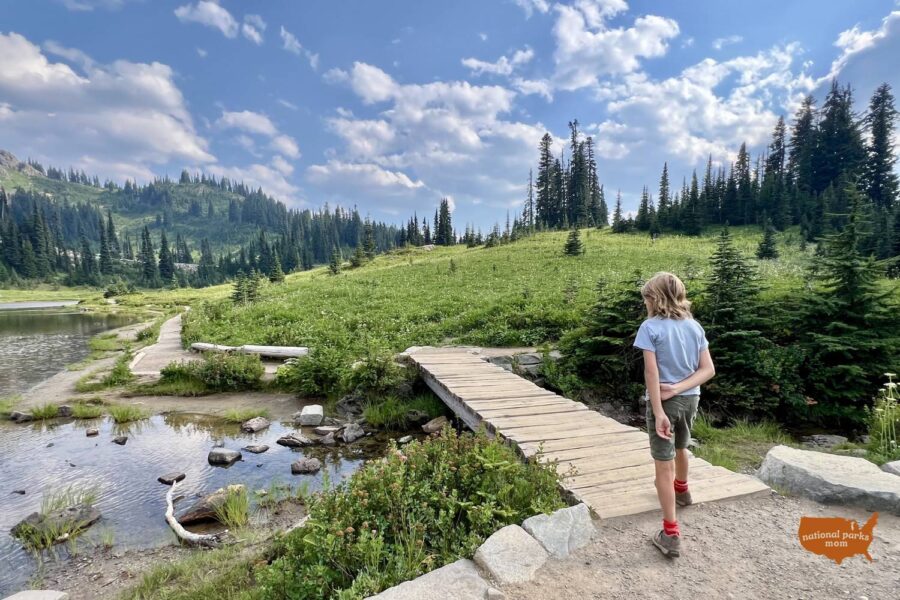 boy walking on a small boardwalk on the Tipsoo Lake Trail, Mt Rainier NP