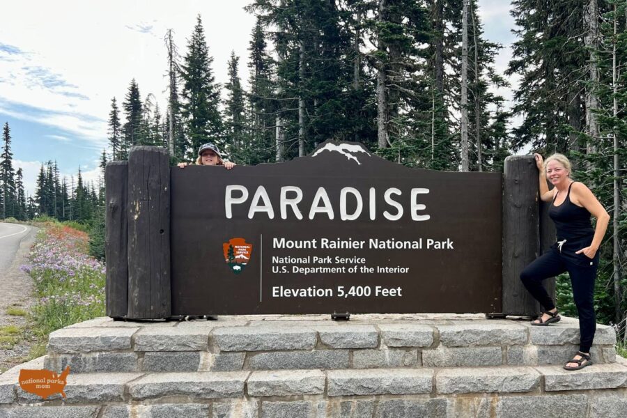 Mother and son at the Paradise Entrance sign, Mt. Rainier NP, Washington state
